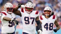 New England Patriots defensive end Milton Williams (97) celebrates sacking Tennessee Titans quarterback Cam Ward (1) during the third quarter at Nissan Stadium in Nashville, Tenn., Sunday, Oct. 19, 2025.