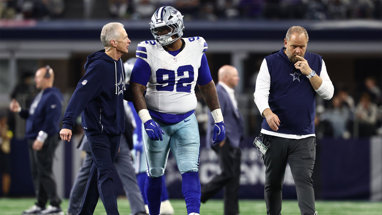 Dallas Cowboys defensive tackle Quinnen Williams (92) walks off the field with trainers after an injury during the second half against the Minnesota Vikings at AT&T Stadium.