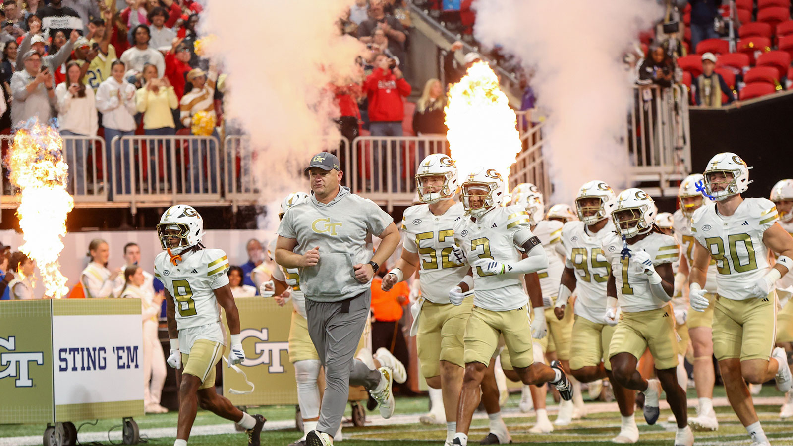 Georgia Tech Yellow Jackets head coach Brent Key leads the team on the field before a game against the Georgia Bulldogs at Mercedes-Benz Stadium.