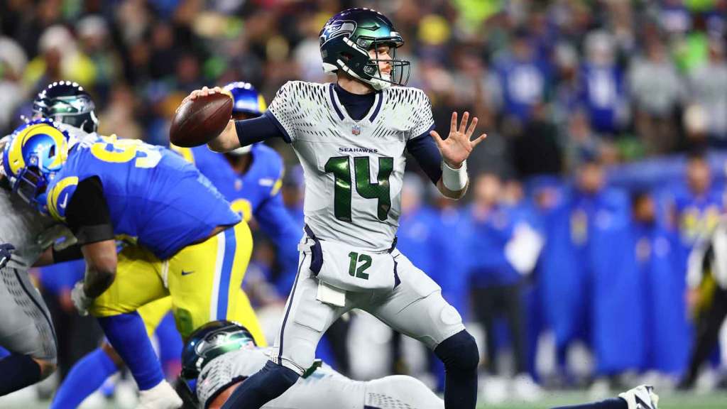 Seattle Seahawks quarterback Sam Darnold (14) throws a pass against the Los Angeles Rams in the second half at Lumen Field.