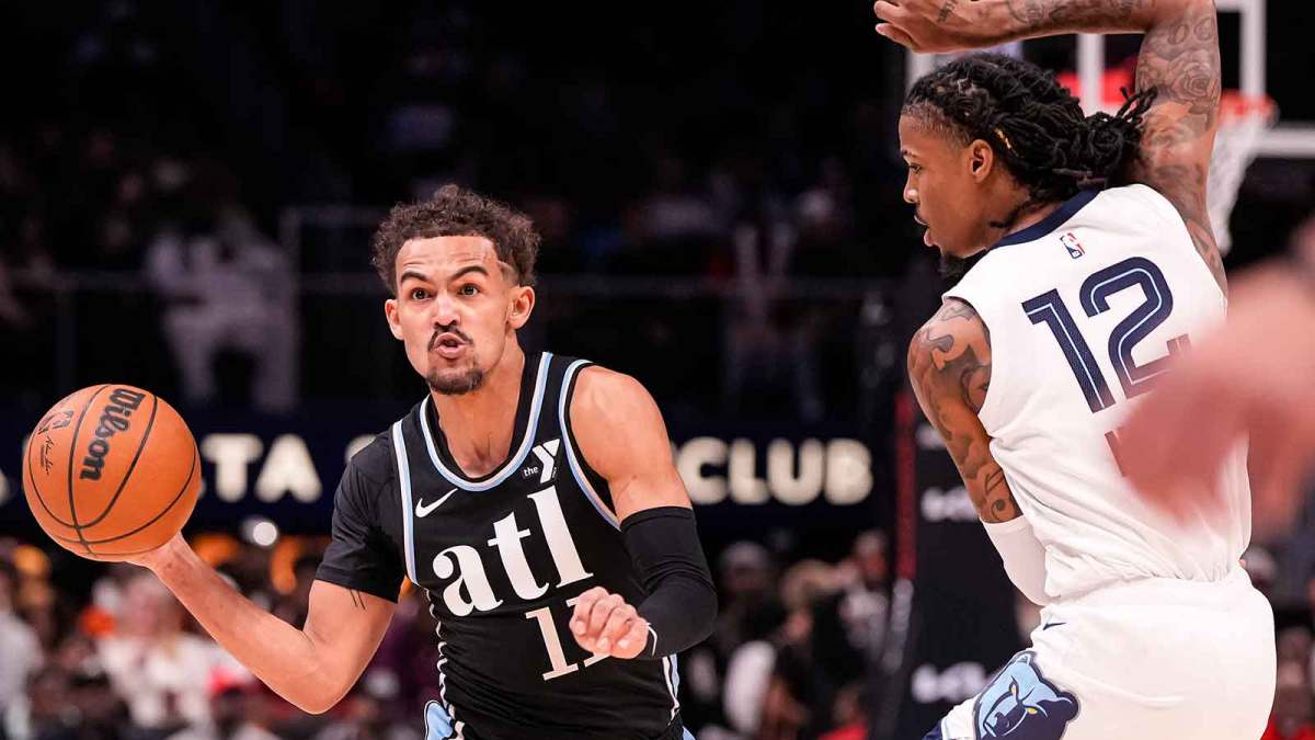 Atlanta Hawks guard Trae Young (11) passes against Memphis Grizzlies guard Ja Morant (12) during the first half at State Farm Arena.