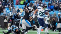Seattle Seahawks running back Zach Charbonnet (26) scores a two-yard rushing touchdown against the Carolina Panthers during the fourth quarter at Bank of America Stadium.