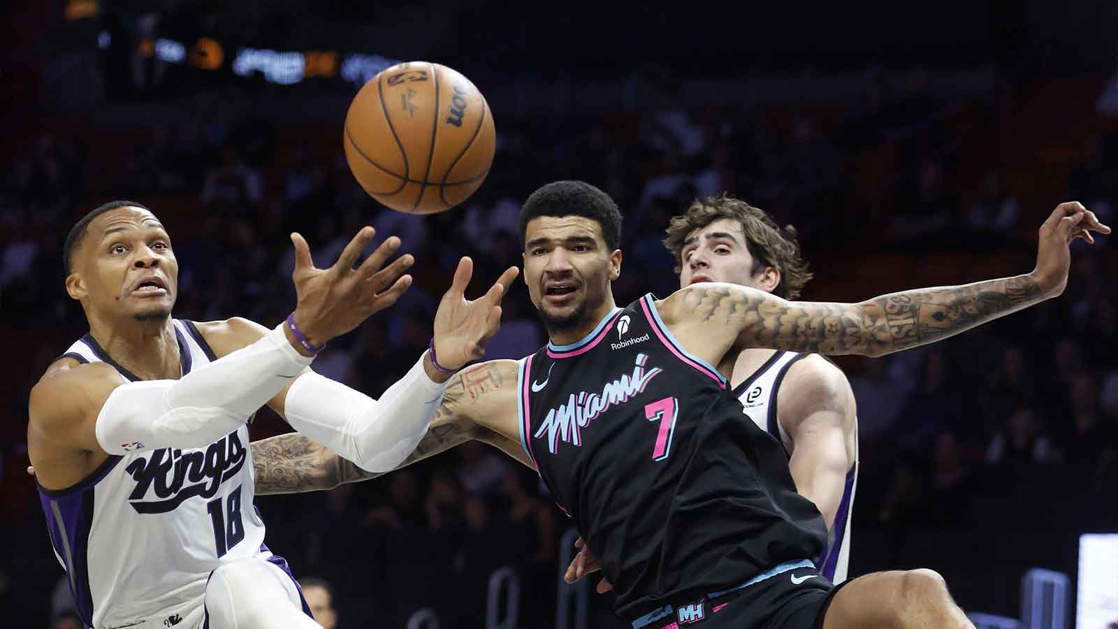 Sacramento Kings guard Russell Westbrook (18) and Miami Heat center Kel'el Ware (7) go for a rebound during the first half at Kaseya Center.