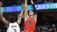 Dec 19, 2025; Cleveland, Ohio, USA; Chicago Bulls center Nikola Vucevic (9) shoots a fade-away shot over Cleveland Cavaliers center-forward Thomas Bryant (3) during the fourth quarter at Rocket Arena. Mandatory Credit: Scott Galvin-Imagn Images