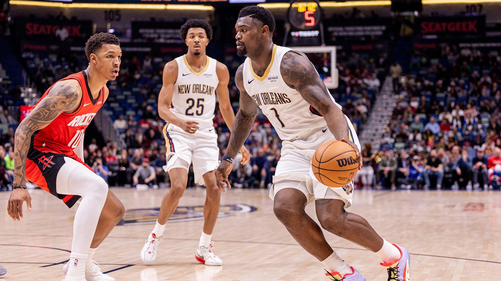 New Orleans Pelicans forward Zion Williamson (1) dribbles against Houston Rockets forward Jabari Smith Jr. (10) during the first half at Smoothie King Center.