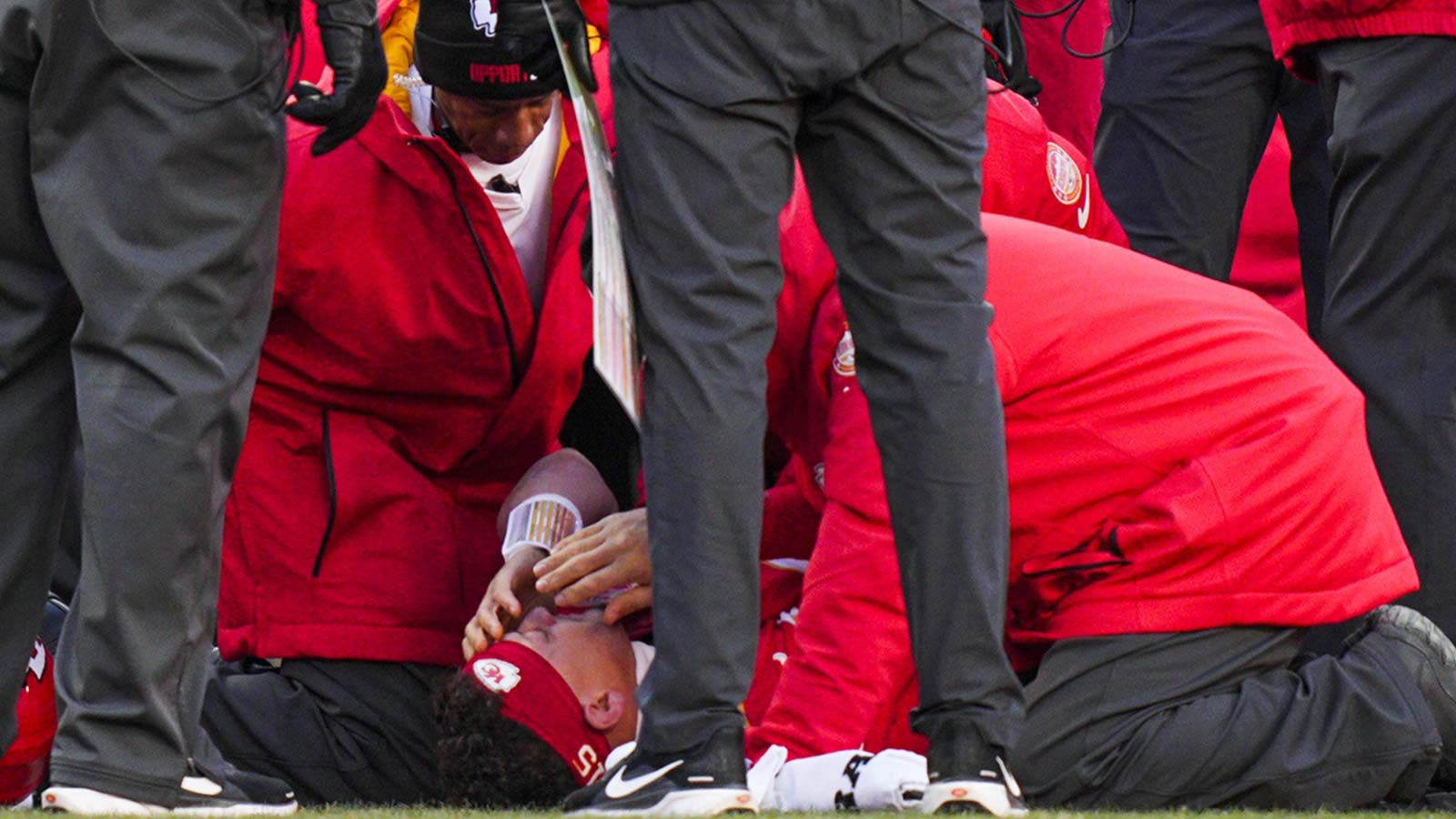 Kansas City Chiefs quarterback Patrick Mahomes (15) is attended to by team medical staff following an injury during the fourth quarter against the Los Angeles Chargers at GEHA Field at Arrowhead Stadium.