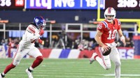 New England Patriots quarterback Drake Maye (10) runs the ball against New York Giants linebacker Zaire Barnes (46) during the fourth quarter at Gillette Stadium.