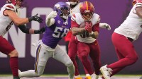 Washington Commanders running back Chris Rodriguez Jr. (36) rushes the ball against Minnesota Vikings linebacker Jonathan Greenard (58) during the first half at U.S. Bank Stadium.