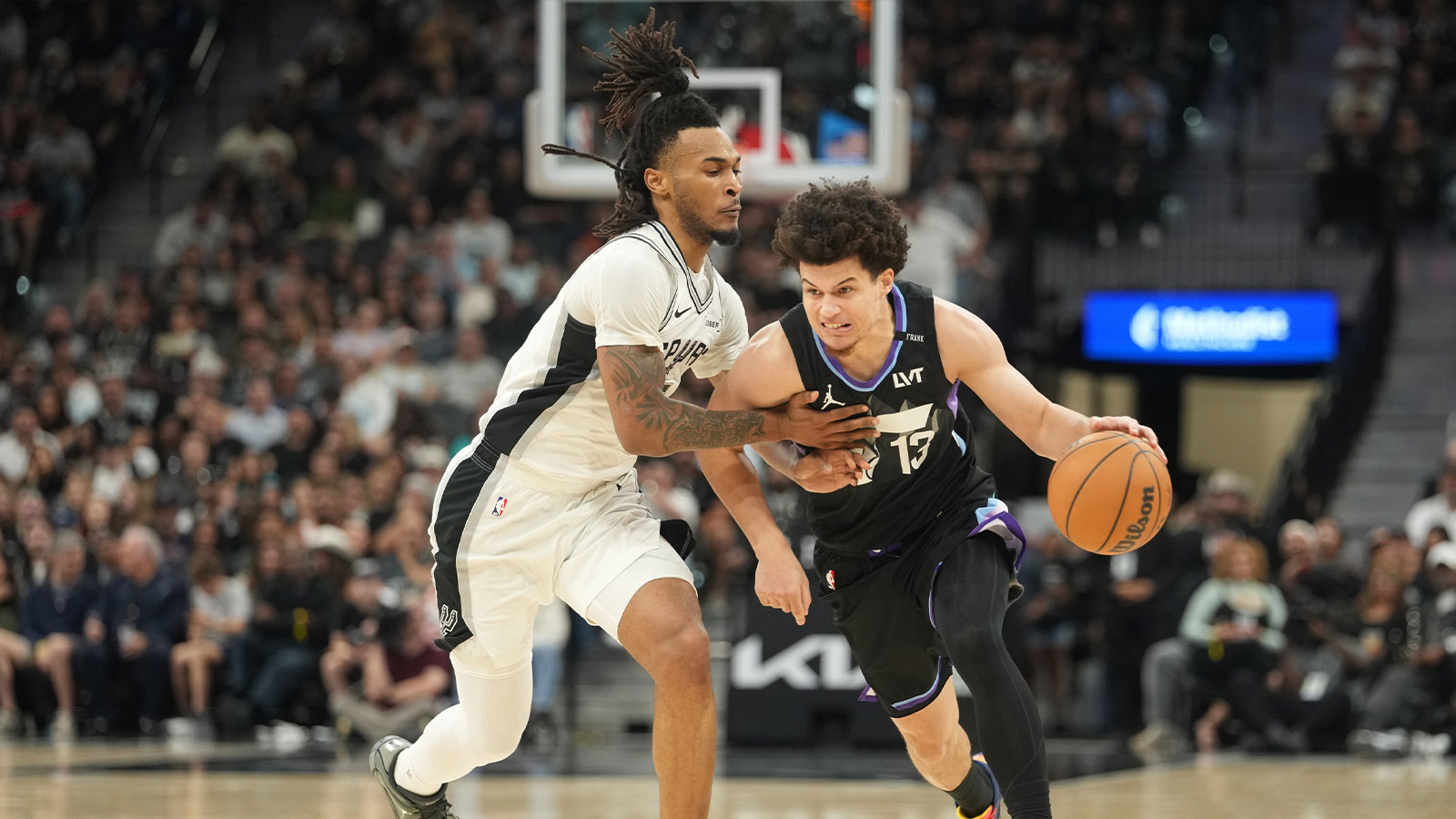 Utah Jazz guard Walter Clayton Jr. (13) drives to the basket against San Antonio Spurs guard Stephon Castle (5) during the first half at Frost Bank Center.