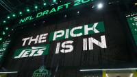 The New York Jets logo is projected on the video board during the NFL Draft at Lambeau Field.
