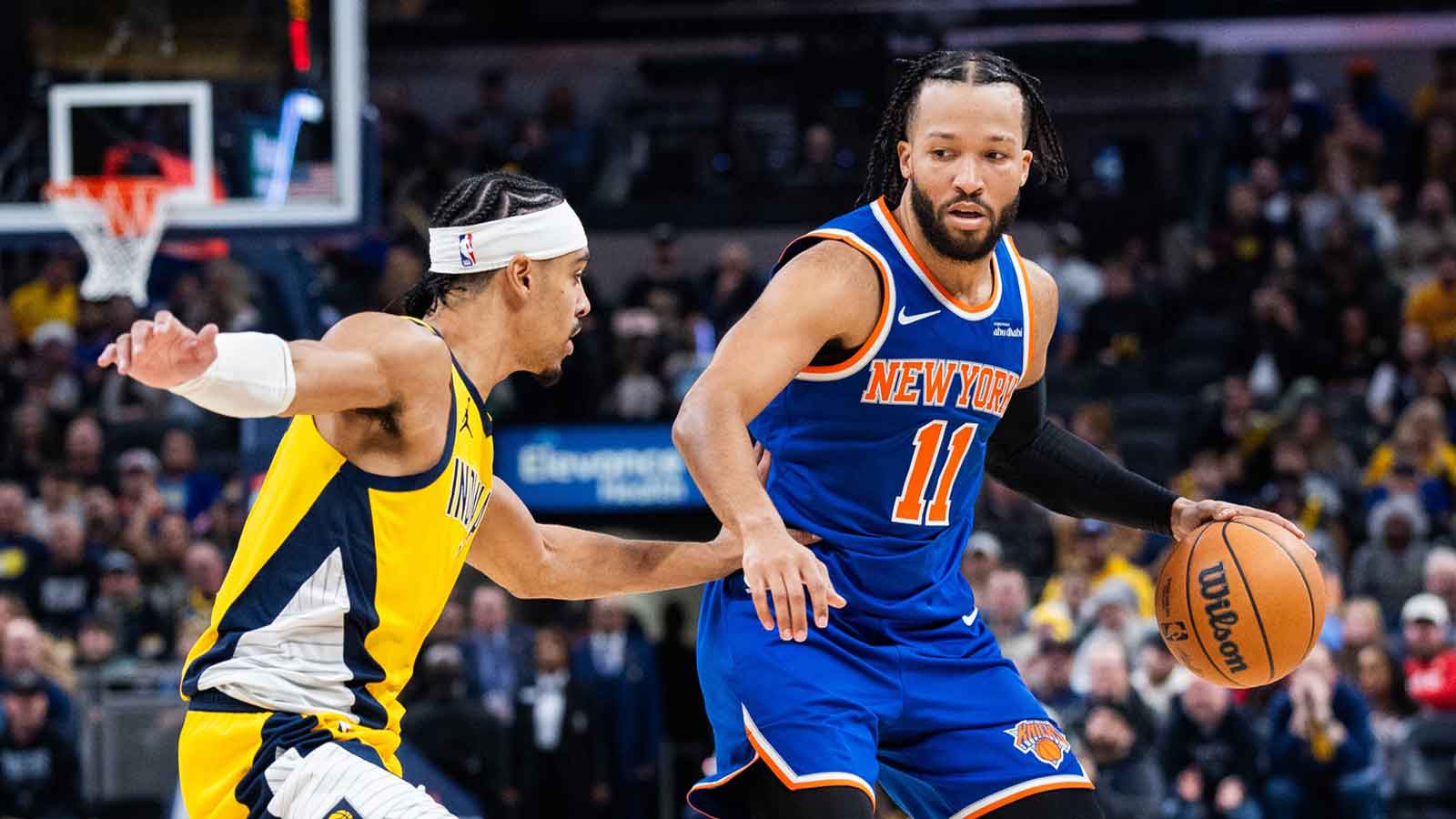 Dec 18, 2025; Indianapolis, Indiana, USA; New York Knicks guard Jalen Brunson (11) dribbles the ball while Indiana Pacers guard/forward Andrew Nembhard (2) defends in the second half at Gainbridge Fieldhouse. Mandatory Credit: Trevor Ruszkowski-Imagn Images