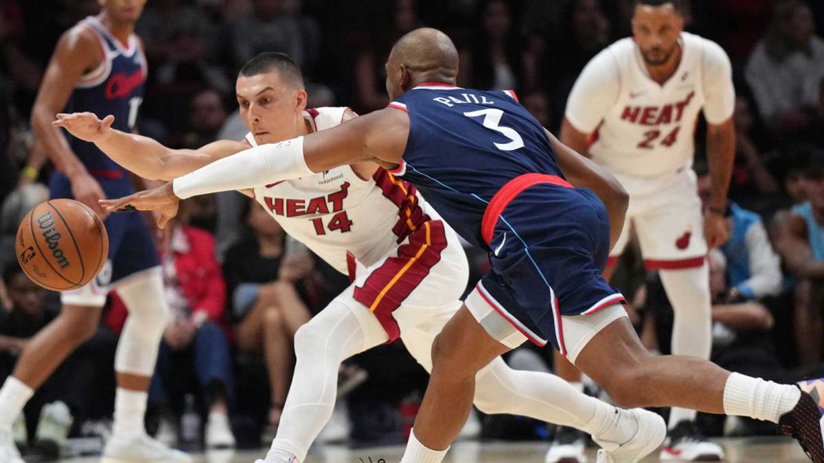 Los Angeles Clippers guard Chris Paul (3) tips the ball away from Miami Heat guard Tyler Herro (14) during the second half at Kaseya Center.