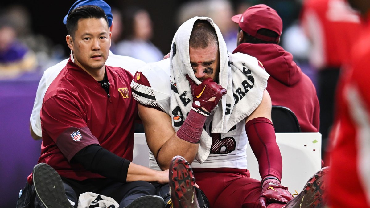 Washington Commanders tight end Zach Ertz (86) is carted off the field after an injury during the second half at U.S. Bank Stadium.