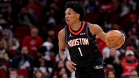 Houston Rockets guard Amen Thompson (1) handles the ball against the Memphis Grizzlies during the first quarter at Toyota Center.