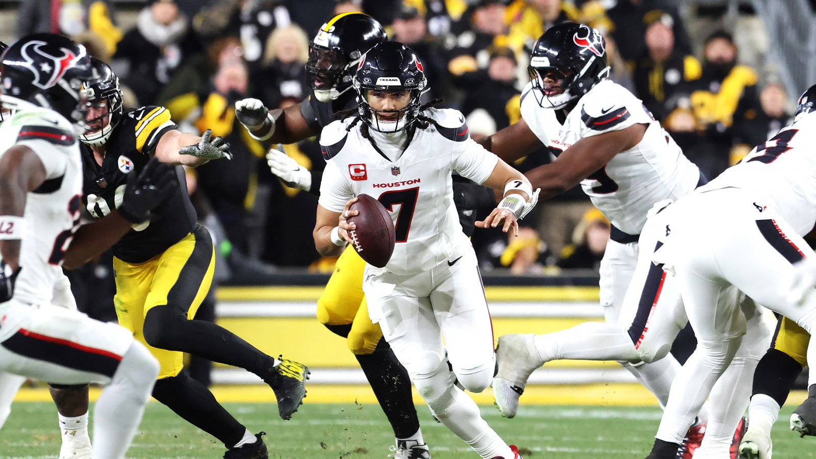 Houston Texans quarterback C.J. Stroud (7) scrambles during the first half of an AFC Wild Card Round game against the Pittsburgh Steelers at Acrisure Stadium.