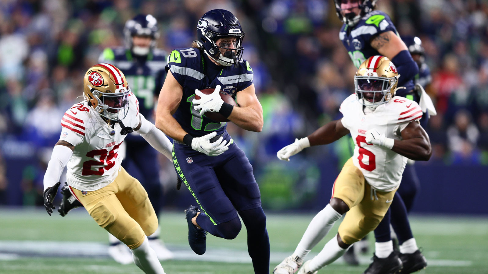 Seattle Seahawks wide receiver Jake Bobo (19) runs after the catch as San Francisco 49ers cornerback Darrell Luter Jr. (28) defends during the first half in an NFC Divisional Round game at Lumen Field.