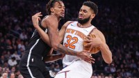New York Knicks center Karl-Anthony Towns (32) looks to drive past Brooklyn Nets center Nic Claxton (33) in the second quarter at Madison Square Garden.