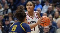 UConn Huskies forward Sarah Strong (21) looks for an opening against Notre Dame Fighting Irish guard Cassandre Prosper (8) in the first half at Harry A. Gampel Pavilion.