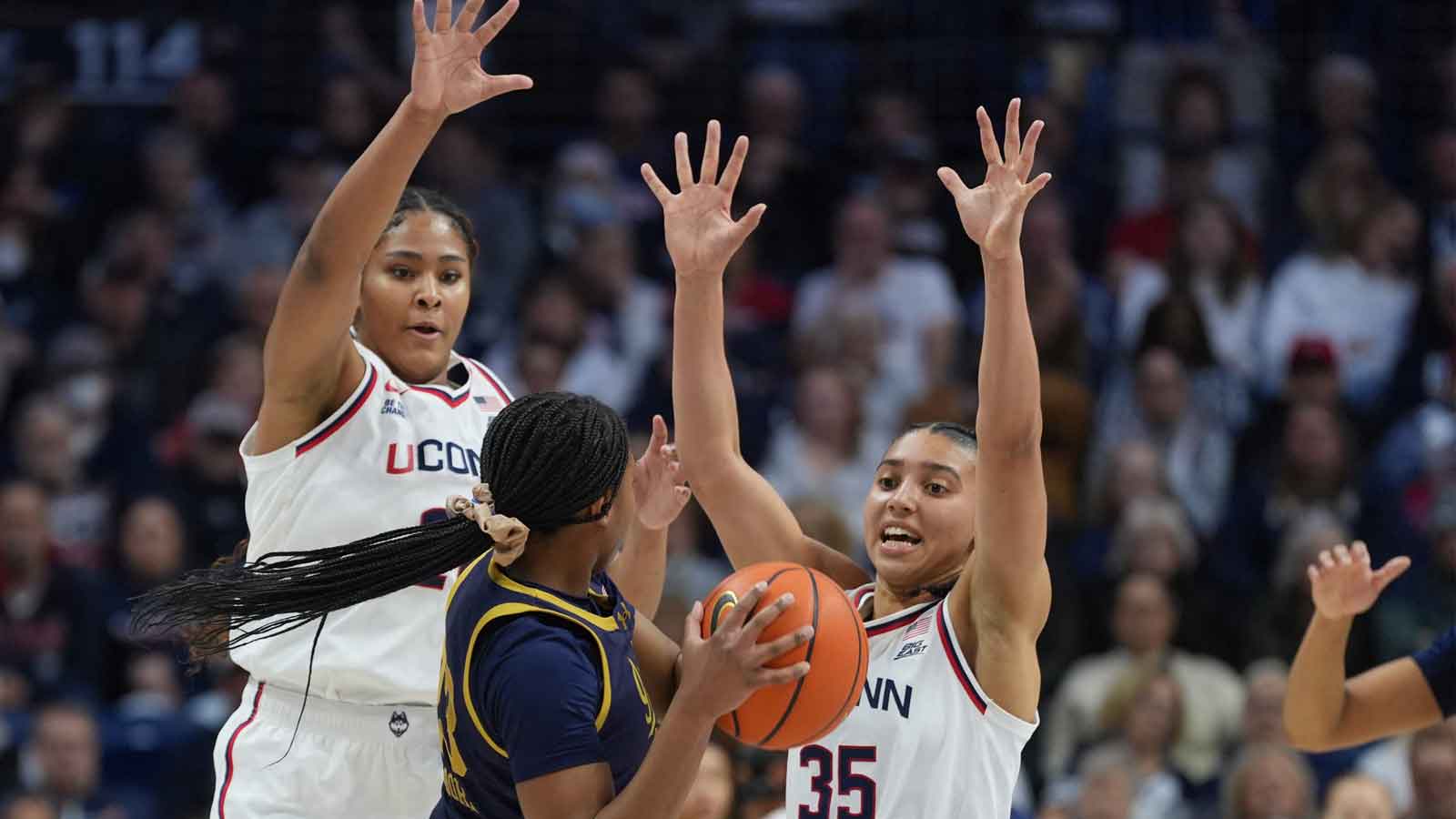 UConn Huskies forward Sarah Strong (21) and guard Azzi Fudd (35) defend against Notre Dame Fighting Irish guard Iyana Moore (23) in the first half at Harry A. Gampel Pavilion.