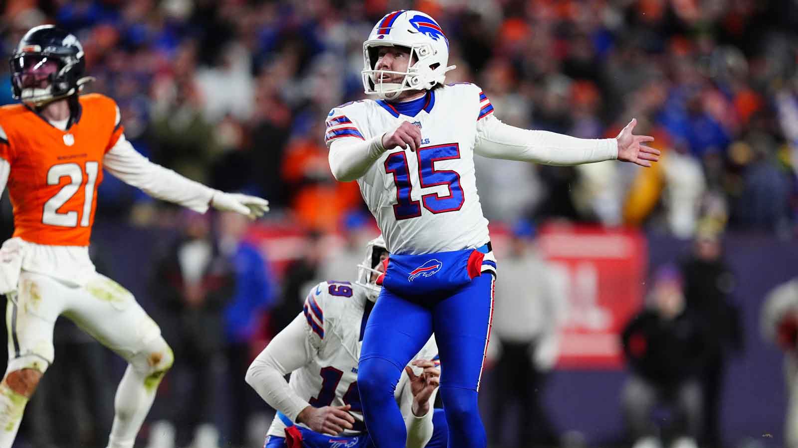Buffalo Bills place kicker Matt Prater (15) kicks a field goal out of the hold of punter Mitch Wishnowsky (19) during the fourth quarter of an AFC Divisional Round playoff game against the Denver Broncos at Empower Field at Mile High.