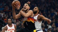 Phoenix Suns guard Devin Booker (1) drives to the basket against New York Knicks guard Mikal Bridges (25) in the first half at Mortgage Matchup Center.