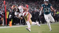 San Francisco 49ers running back Christian McCaffrey (23) makes a catch for a touchdown defended by Philadelphia Eagles safety Reed Blankenship (32) during the fourth quarter in an NFC Wild Card Round game at Lincoln Financial Field.