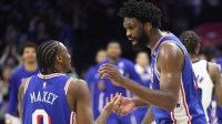 76ers center Joel Embiid talks to Tyrese Maxey