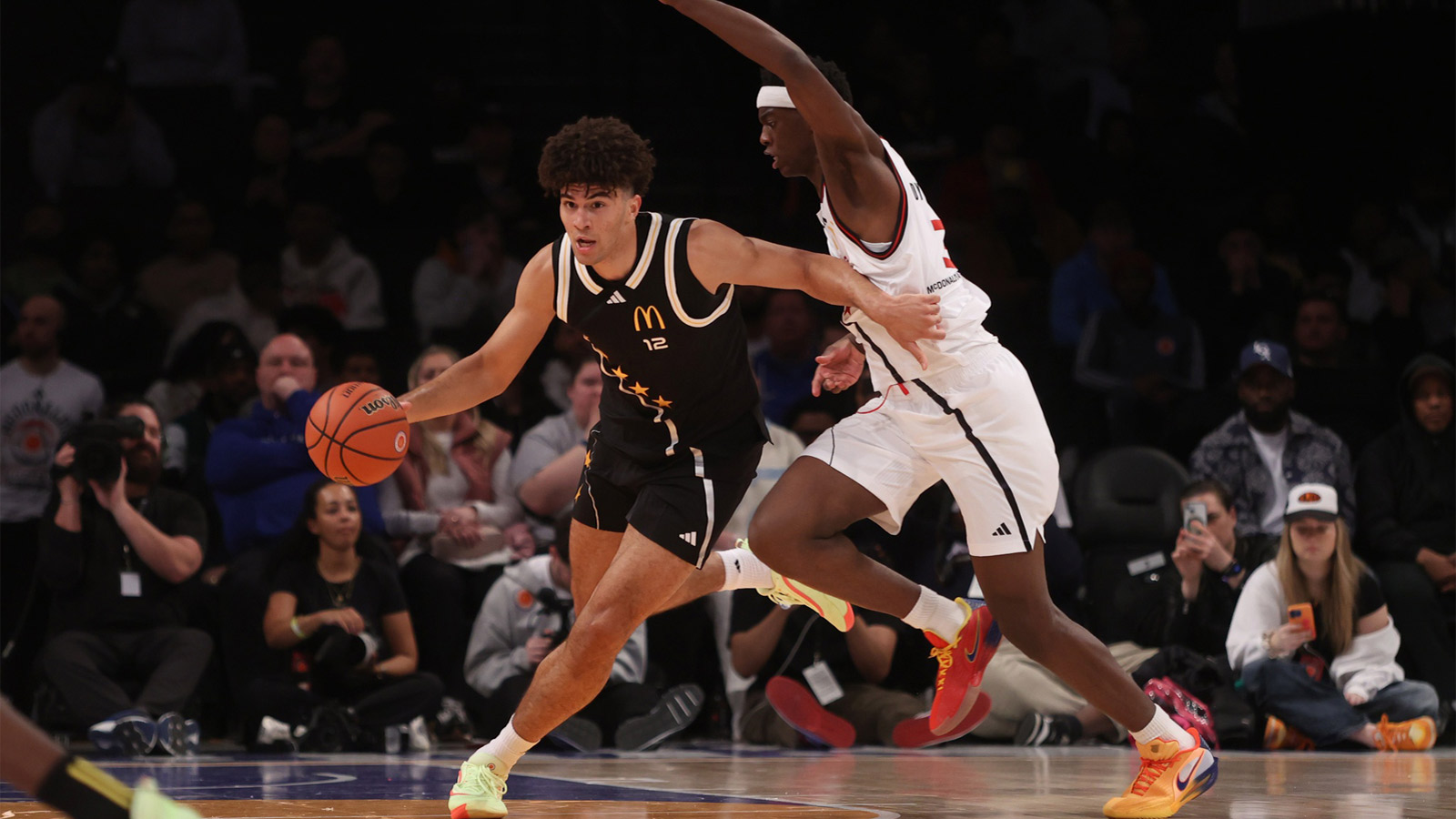 McDonald's All American East forward Cameron Boozer (12) dribbles the ball against McDonald's All American West forward AJ Dybantsa (3) during the second half of the game at Barclays Center.