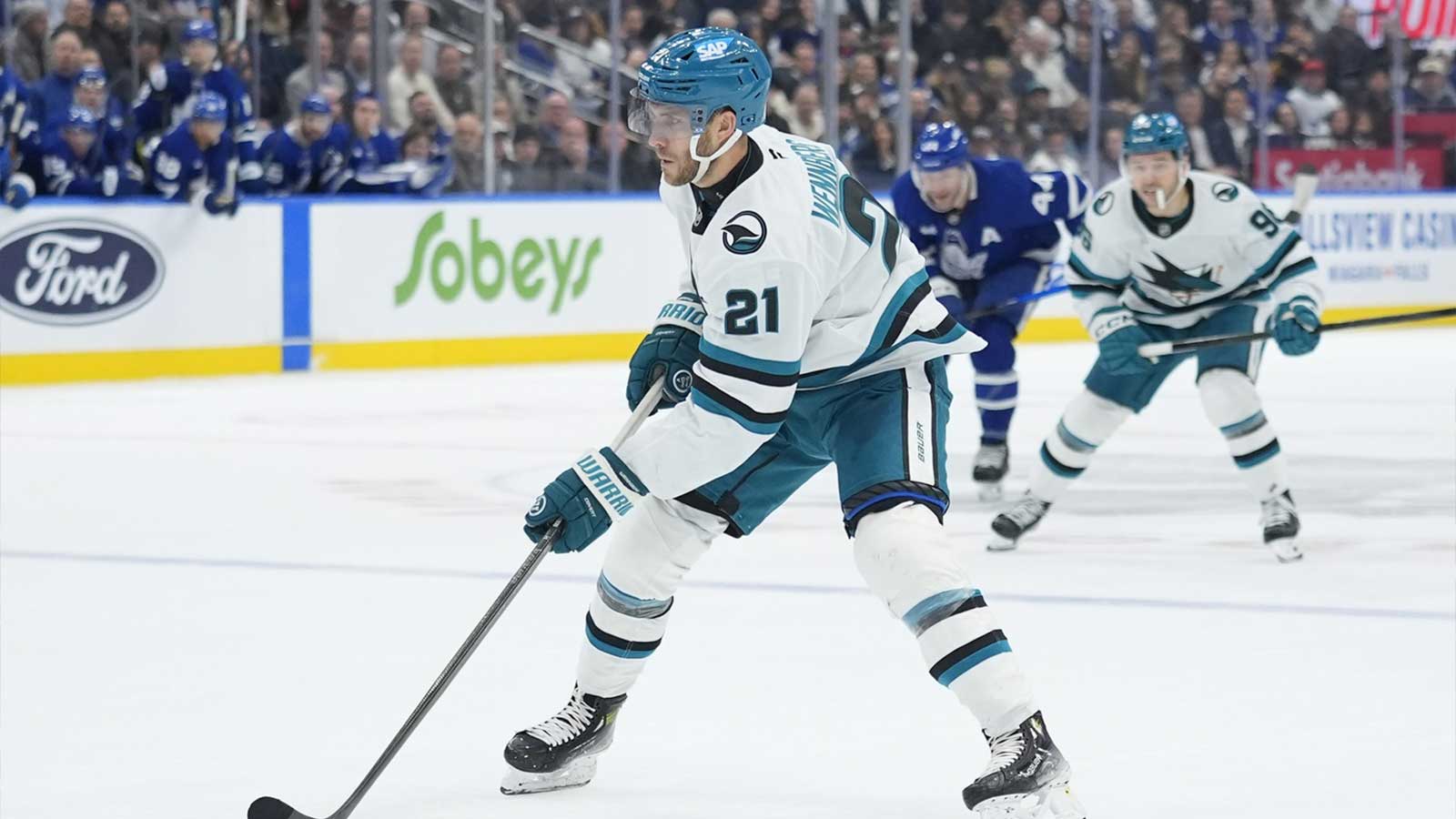 San Jose Sharks forward Alex Wennberg (21) carries the puck against the Toronto Maple Leafs during overtime at Scotiabank Arena.