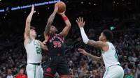 Toronto Raptors guard Alijah Martin (55) shoots the ball against Boston Celtics guard Anfernee Simons (4) and guard Hugo Gonzalez (28) n the second half at TD Garden.