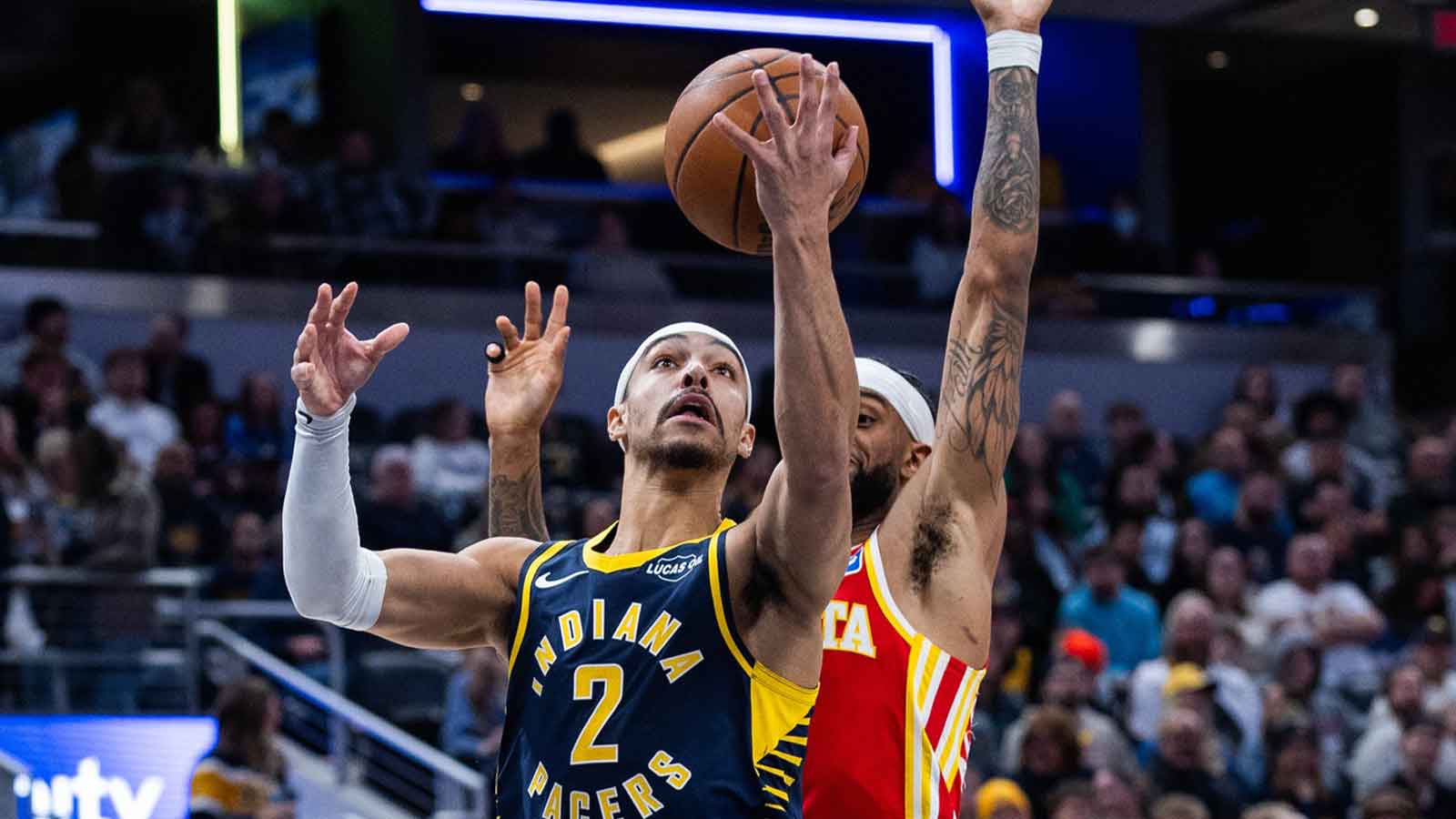 Indiana Pacers guard/forward Andrew Nembhard (2) shoots the ball while Atlanta Hawks guard Nickeil Alexander-Walker (7) defends in the first half at Gainbridge Fieldhouse.