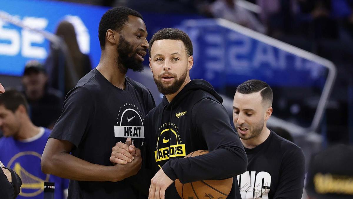 Miami Heat forward Andrew Wiggins (22) and Golden State Warriors guard Stephen Curry (30) greet each other before the game at Chase Center.
