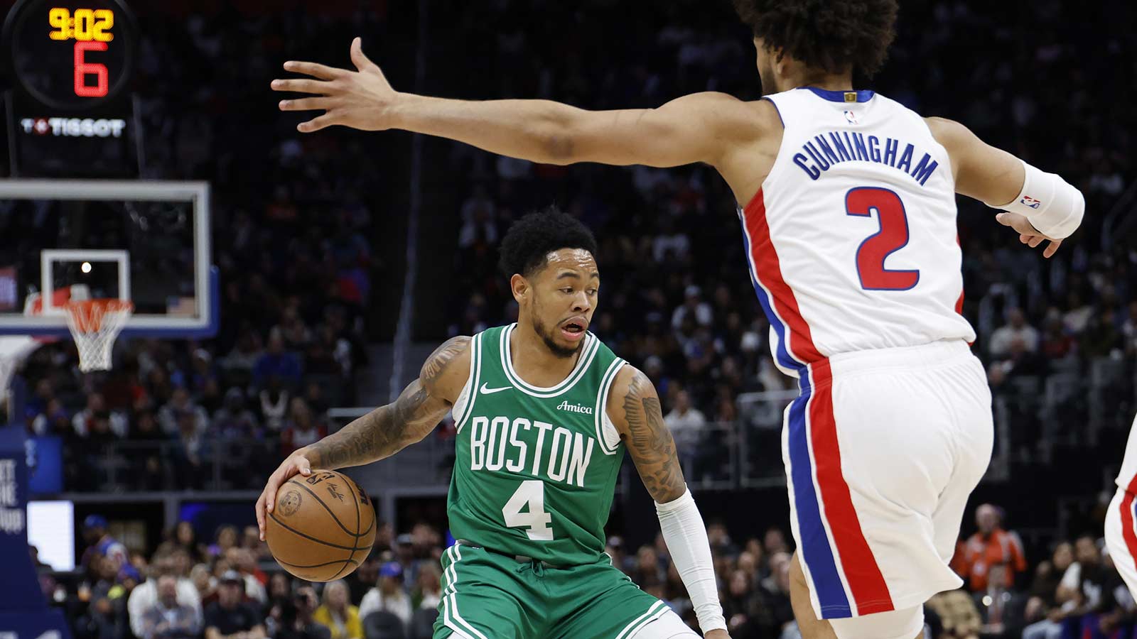 Boston Celtics guard Anfernee Simons (4) reacts as his dribbles the ball against Detroit Pistons guard Cade Cunningham (2) in the first half at Little Caesars Arena. 