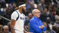 Dallas Mavericks forward Anthony Davis (l3) and guard Kyrie Irving (right) speak during a second half break in action against the Utah Jazz at Delta Center.