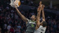 Minnesota Timberwolves guard Anthony Edwards (5) drives to the basket past San Antonio Spurs guard De'aaron Fox (4) in the second half at Target Center.