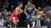 Minnesota Timberwolves guard Anthony Edwards (5) dribbles the ball as Chicago Bulls guard Tre Jones (30) defends in the second half at Target Center.