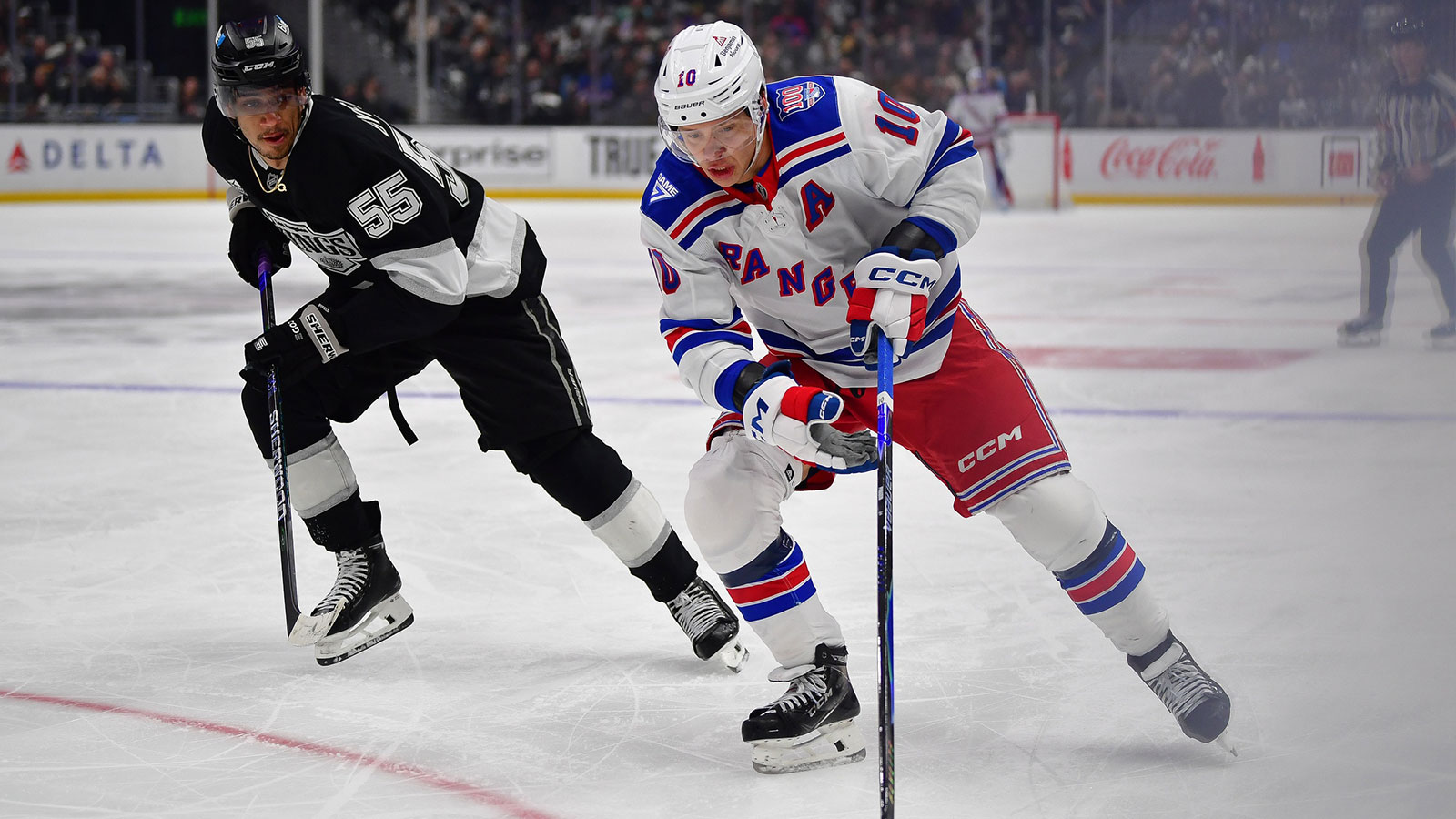 New York Rangers left wing Artemi Panarin (10) moves the puck against Los Angeles Kings right wing Quinton Byfield (55) during the third period at Crypto.com Arena.