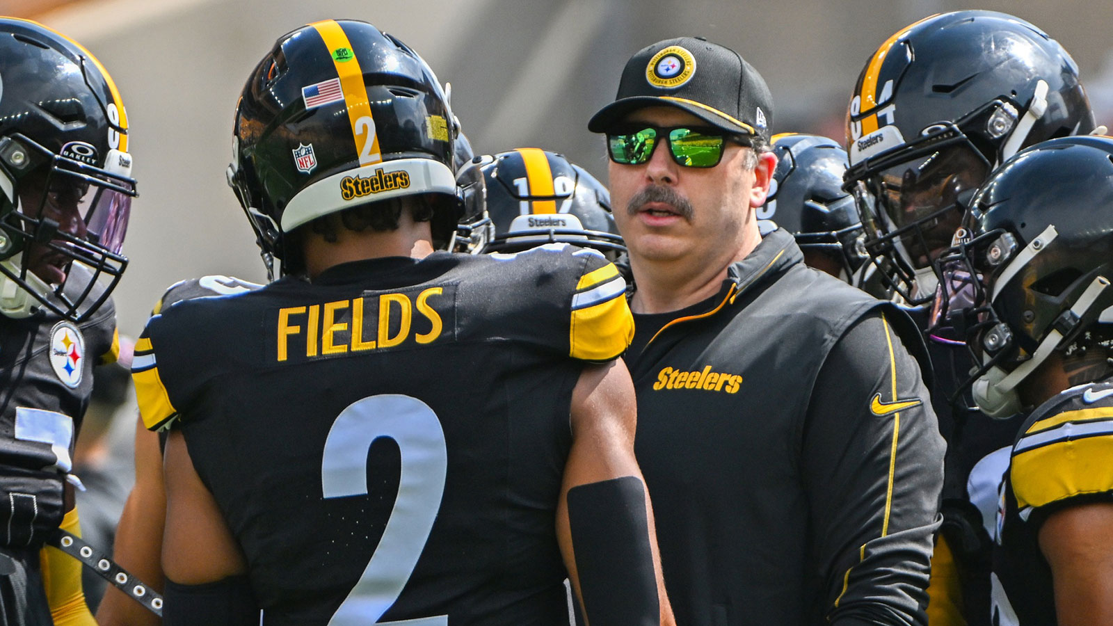 Pittsburgh Steelers offensive coordinator Arthur Smith talks with quarterback Russell Wilson (3) during warmups for a game against the Los Angeles Chargers at Acrisure Stadium.
