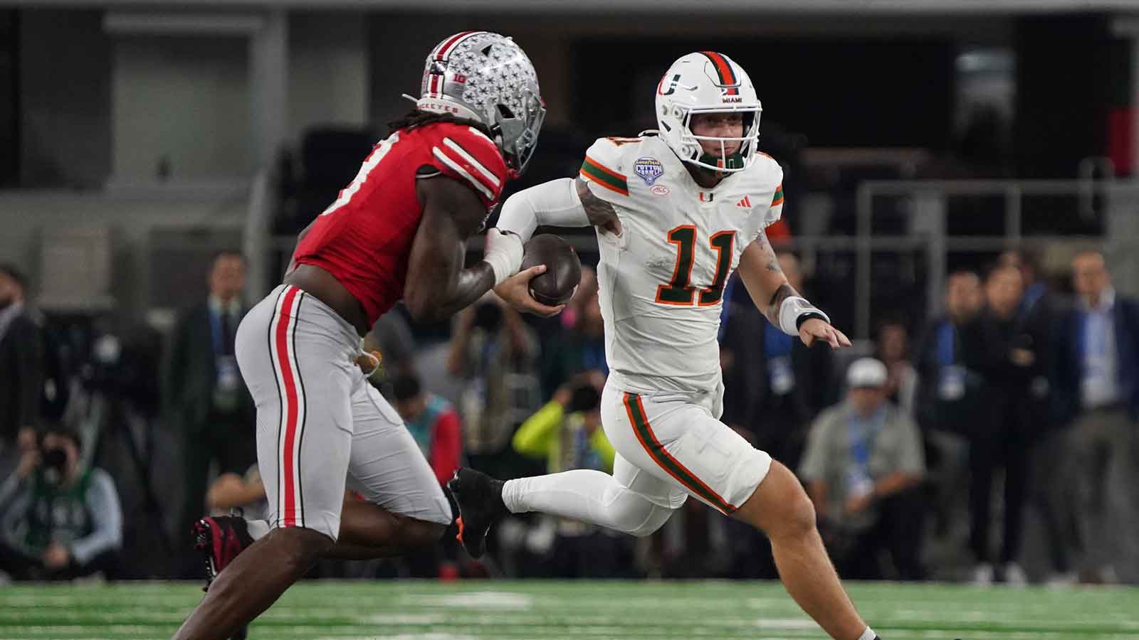 Miami Hurricanes quarterback Carson Beck (11) carries the ball as Ohio State Buckeyes linebacker Arvell Reese (8) defends during second half the 2025 Cotton Bowl and quarterfinal game of the College Football Playoff at AT&T Stadium.