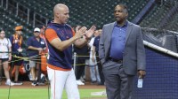 Houston Astros manager Joe Espada (left) and general manager Dana Brown (right) talk on the field before the game against the Chicago Cubs at Daikin Park