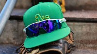 General view of an Oakland Athletics hat, glove glasses prior to a Spring Training game against the Chicago Cubs at Sloan Park.