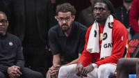Atlanta Hawks guard Trae Young (11) (left in black shirt) sits on the end of the bench during the game against the New Orleans Pelicans during the second half at State Farm Arena.