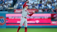 Cincinnati Reds right fielder Austin Hays (12) celebrates an RBI double in the first inning of the MLB National League Wild Card Game 2 between the Los Angeles Dodgers and the Cincinnati Reds at Dodger Stadium.