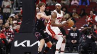 Chicago Bulls forward Matas Buzelis (14) defends against Miami Heat center Bam Adebayo (13) during the first half at United Center.