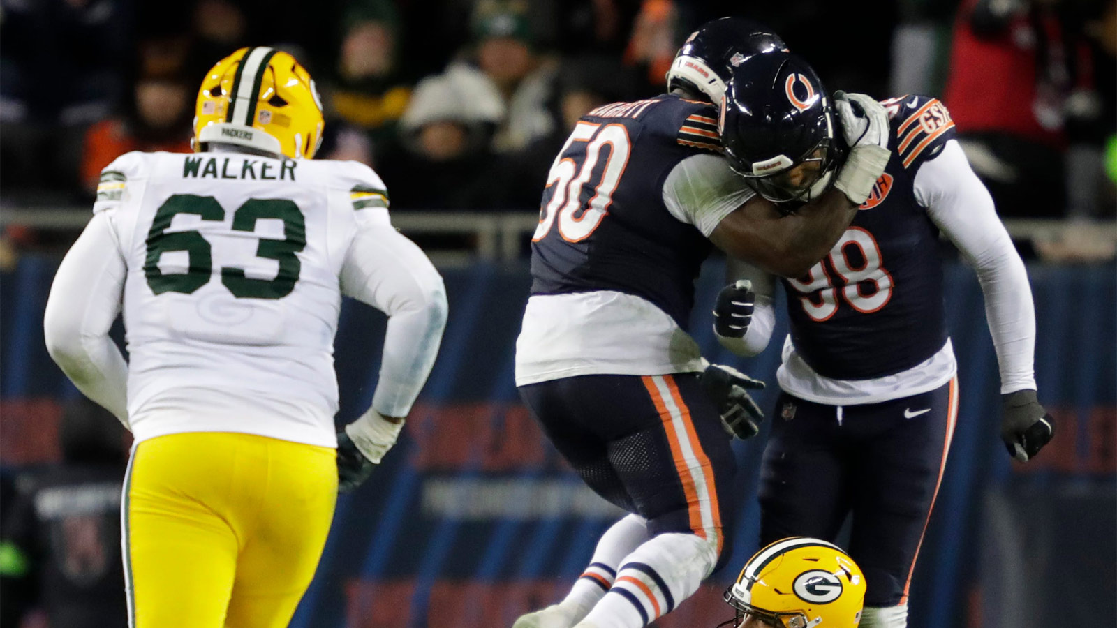 Chicago Bears defensive end Grady Jarrett (50) and defensive end Montez Sweat (98) celebrates forcing an incomplete pass by Green Bay Packers quarterback Jordan Love (10) in the fourth quarter during their wild-card playoff football game Saturday, January 10, 2026, at Soldier Field in Chicago, Illinois.