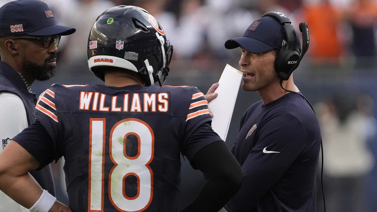 Chicago Bears head coach Ben Johnson talks with quarterback Caleb Williams (18) against the Dallas Cowboys during the second half at Soldier Field. 