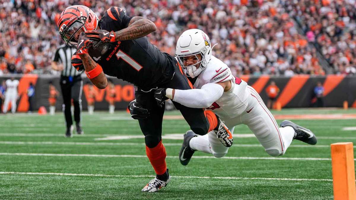 Cincinnati Bengals wide receiver Ja'Marr Chase (1) breaks a tackle from Arizona Cardinals linebacker Cody Simon (50) as he dives into the end zone for a touchdown in the first quarter of the NFL Week 17 game between the Cincinnati Bengals and the Arizona Cardinals at Paycor Stadium in Downtown Cincinnati on Sunday, Dec. 28, 2025. The Bengals led 23-7 at halftime.