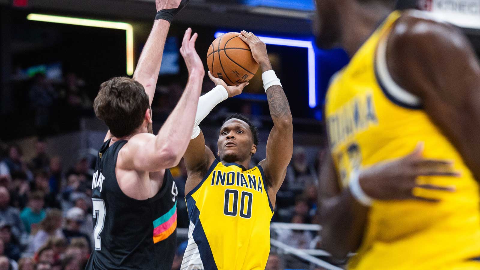Indiana Pacers guard/forward Bennedict Mathurin (00) shoots the ball while San Antonio Spurs center/forward Luke Kornet (7) defends in the first half at Gainbridge Fieldhouse.
