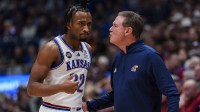 Kansas Jayhawks guard Darryn Peterson (22) talks to head coach Bill Self during the first half against the Iowa State Cyclones at Allen Fieldhouse.