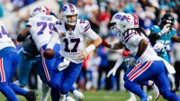 Buffalo Bills quarterback Josh Allen (17) hands off to Buffalo Bills running back James Cook III (4) during the first quarter in an NFL football AFC Wild Card playoff matchup.
